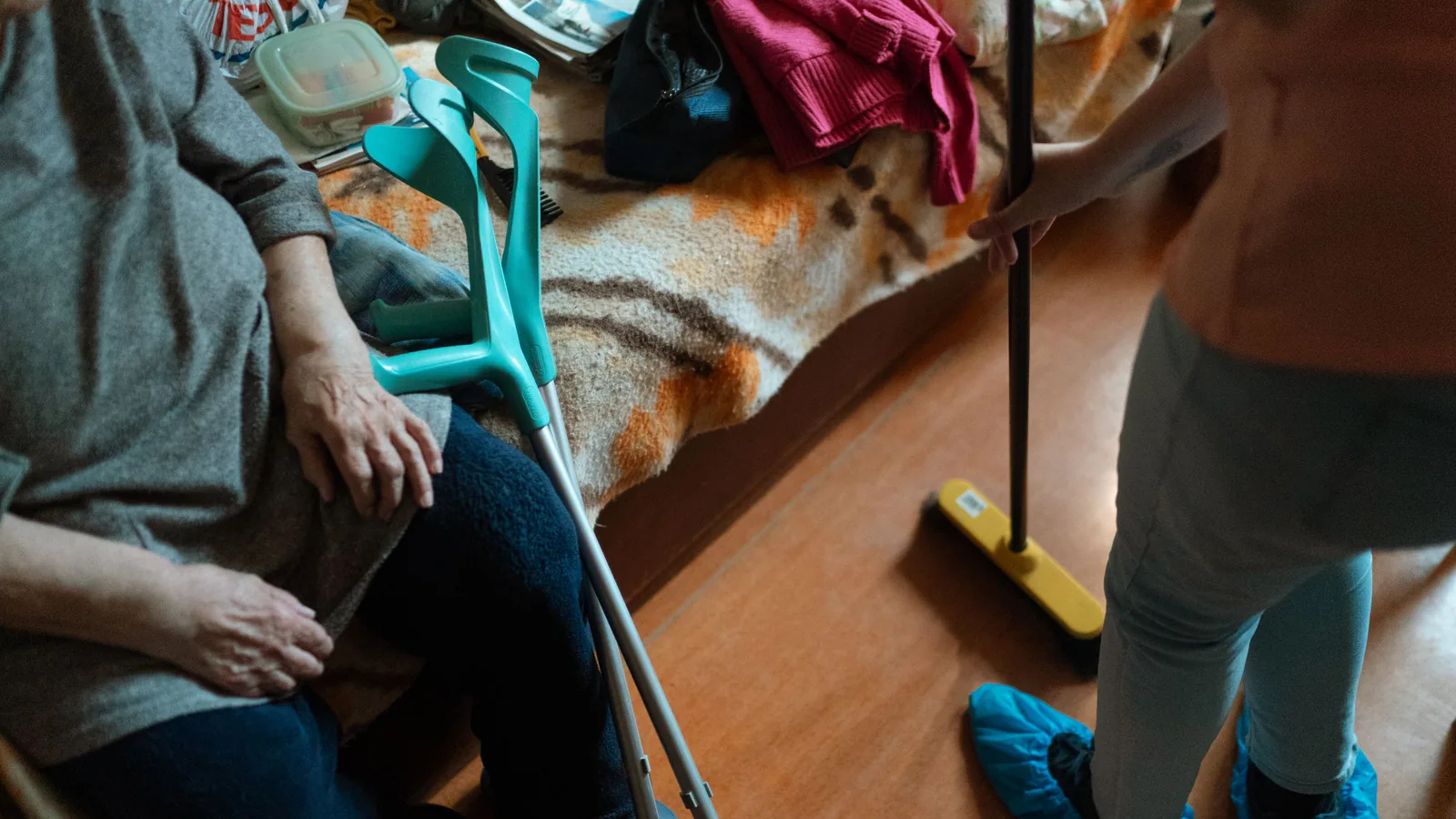 Franquicias de servicios a la persona: oportunidades en auge | ZonaFranquicia Cuidadora ayudando a mujer mayor con tareas de limpieza en el hogar, mostrando apoyo en cuidados domésticos | ZonaFranquicia